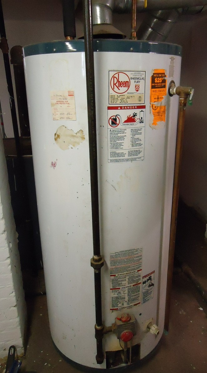 A household water heater with supply lines and a vent